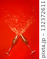 New Year's, confetti spilling out of champagne glasses on a red background 132372611