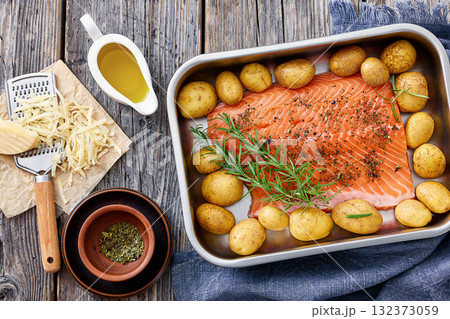 raw salmon fillet with baby potato in baking dish 132373059
