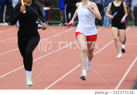 Relay Race at Track Meet With Runners in Action 132373138