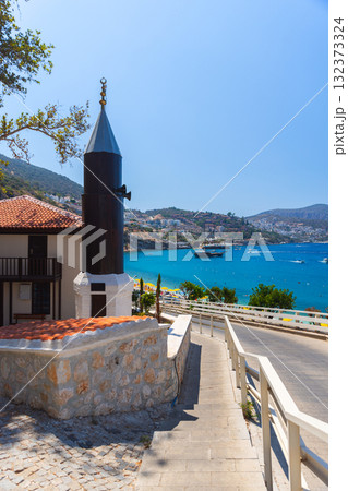 Kalkan street view with minaret of Lamibey Camii. Sunny coastal scene 132373324