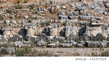 Weathered ancient ruins reveal crumbling colonnade fragments 132373329
