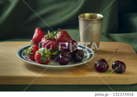Fresh Strawberries and Cherries on Plate With Metallic Cup On Wooden Surface Fresh Strawberries and Cherries on Plate With Metallic Cup On Wooden Surface 132373458