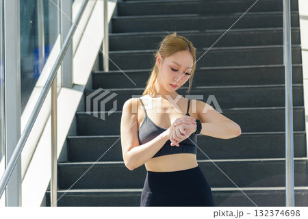 Woman checks sport watch, monitoring exercise data, outdoor workout, fit girl, ready for more physical exercise, embracing active lifestyle, inspiring healthy fitness people Woman checks sport watch, monitoring exercise data, outdoor workout, fit girl, ready for more physical exercise, embracing active lifestyle, inspiring healthy fitness people 132374698