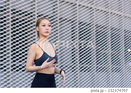 Exercise woman performs sport workout, fit body preparing for outdoor activity, people focused on healthy lifestyle, dynamic stretch overall wellbeing, fitness, strong body and mindful exercise 132374707