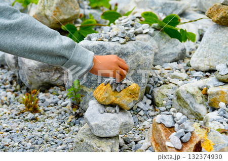 Relaxed spiritually child's hand arrangement pebble tower. Yoga relax meditation Relaxed spiritually child's hand arrangement pebble tower. Yoga relax meditation 132374930
