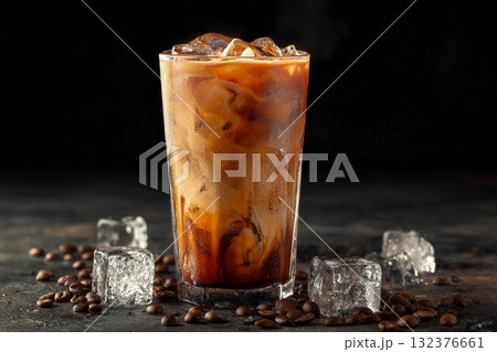 Cold Brew Coffee Served in a Tall Glass With Ice and Coffee Beans on a Dark Background 132376661
