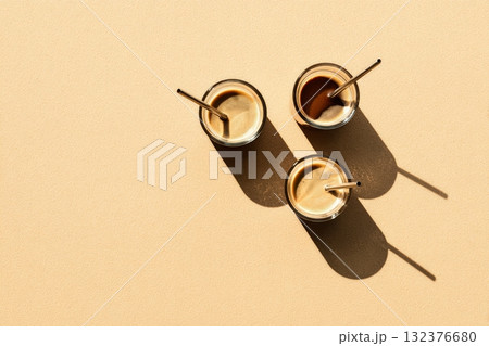 Delicious Coffee Drinks With Straws Arranged on a Warm Background in an Inviting Setting 132376680