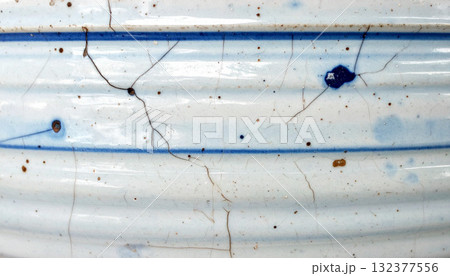 Cracked Ceramic Pot with Blue Detailing Texture Background 132377556