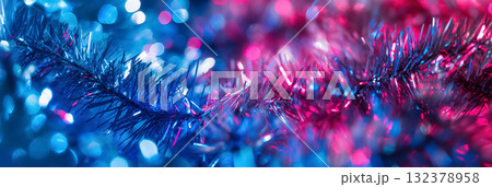 Shimmering blue and red tinsel captured in a close-up, highlighting the festive sparkle and vivid colors. 132378958