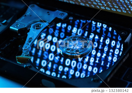 A hard disk with a blue binary code A hard disk with a blue binary code 132380142
