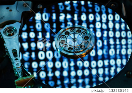 A hard disk with a blue binary code A hard disk with a blue binary code 132380143