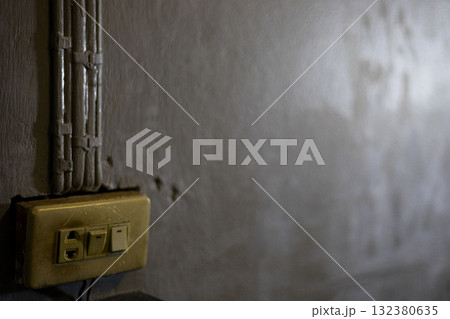 Old Power and Light Switch in Warm Light, Old power and light switch glows softly in warm light, showcasing vintage charm, perfect for promoting retro home restoration products. Old Power and Light Switch in Warm Light, Old power and light switch glows softly in warm light, showcasing vintage charm, perfect for promoting retro home restoration products. 132380635