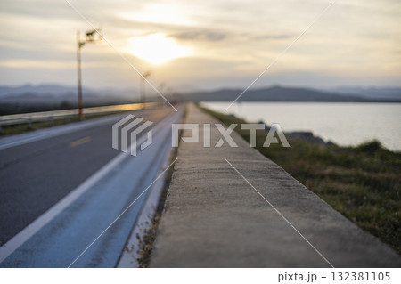 Dusk Over Countryside Dam And River, A serene dusk settles over a countryside dam and river, golden hues reflecting on still waters, perfect for landscape photography shot or rural twilight showcase. Dusk Over Countryside Dam And River, A serene dusk settles over a countryside dam and river, golden hues reflecting on still waters, perfect for landscape photography shot or rural twilight showcase. 132381105