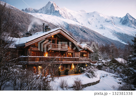 The winter vacation chalet features a warm interior with blankets and drinks, showcasing breathtaking mountain views enveloped in a serene snow-covered landscape The winter vacation chalet features a warm interior with blankets and drinks, showcasing breathtaking mountain views enveloped in a serene snow-covered landscape 132381338