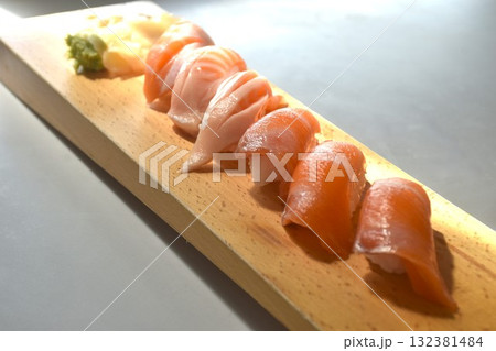 salmon Sushi Japanese food with wasabi dipping soy sauce on long wooden plate salmon Sushi Japanese food with wasabi dipping soy sauce on long wooden plate 132381484