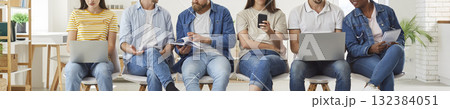 People sitting in row in office, waiting for work meeting, talking and using laptops and phones People sitting in row in office, waiting for work meeting, talking and using laptops and phones 132384051