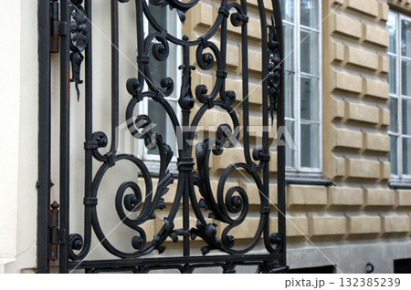 gate and windows of a tenement house, yellow wall 132385239