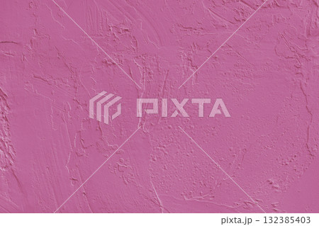 Close up pink colored painted plaster wall surface background with rough brushstrokes texture 132385403