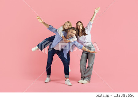 Playful young family having fun on pink...の写真素材 [132385656] - PIXTA