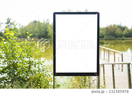 Blank vertical billboard mockup near lake in natural park Blank vertical billboard mockup near lake in natural park 132385978