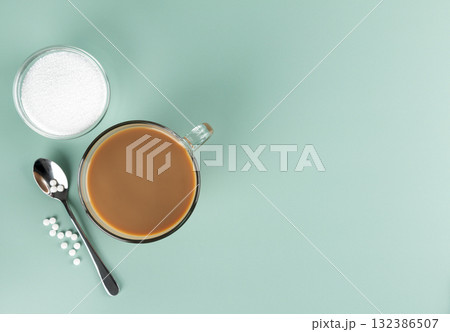 A cup of coffee with milk and natural stevia sweetener on a blue background. Top view. Copy space. 132386507