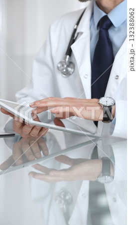 Doctor discussing medical information, explaining diagnosis and treatment to a patient in a consultation room. Medicine and health care Doctor discussing medical information, explaining diagnosis and treatment to a patient in a consultation room. Medicine and health care 132388062