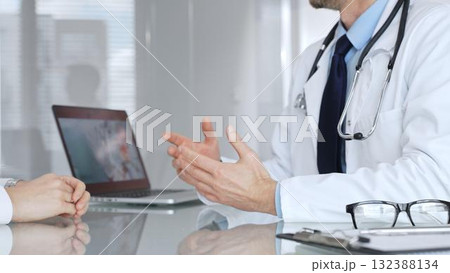 Doctor consulting patient about healthcare, discussing diagnosis, offering medical advice in clinic. Medicine, healthcare and science concept Doctor consulting patient about healthcare, discussing diagnosis, offering medical advice in clinic. Medicine, healthcare and science concept 132388134