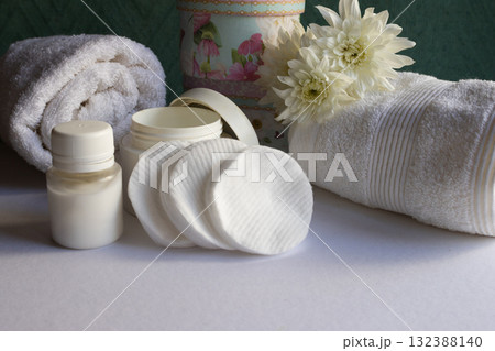 Aesthetic spa composition with skin care creams and cotton pads, ideal for advertisements for modern spas. Aesthetic spa composition with skin care creams and cotton pads, ideal for advertisements for modern spas. 132388140