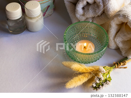 Elegant spa composition with rolled towels , wild flowers and aroma candles. Copy space Elegant spa composition with rolled towels , wild flowers and aroma candles. Copy space 132388147