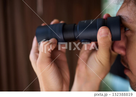 A Person Diligently Using a Telescope for Detailed Observation of the Night Sky and Beyond A Person Diligently Using a Telescope for Detailed Observation of the Night Sky and Beyond 132388819