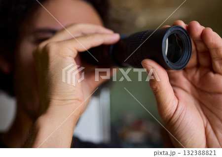 A Person Diligently Using a Telescope for Detailed Observation of the Night Sky and Beyond 132388821