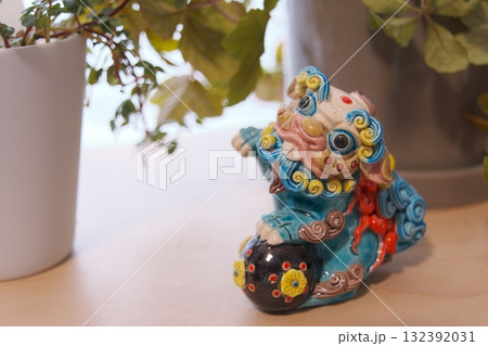 窓辺の観葉植物と獅子の置物 132392031