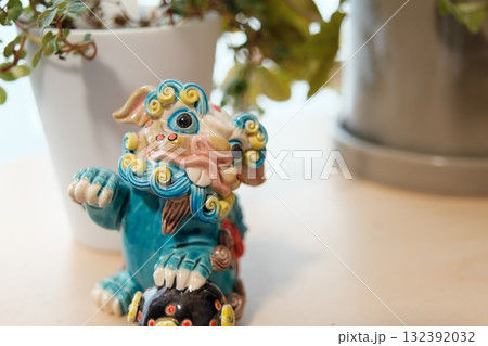 窓辺の観葉植物と獅子の置物 132392032