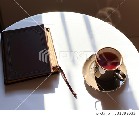 Quiet Moment: A Book, Tea, and Sunlight's Embrace 132398033