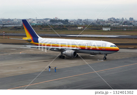 出発する飛行機に手を振るグランドスタッフ 出発する飛行機に手を振るグランドスタッフ 132401302