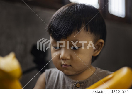 Toddler Playing In Bedroom, heartwarming detail designed for interior decor visuals, toy ads, lifestyle campaigns, and parenting or early childhood projects. 132401524