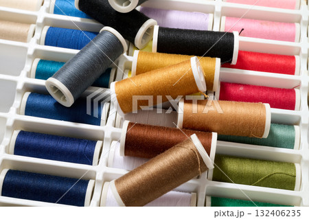 spools of multicolored sewing thread 132406235