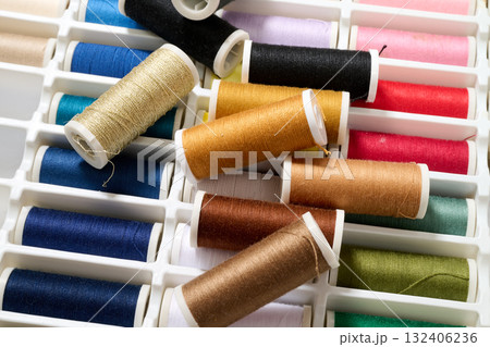 spools of multicolored sewing thread 132406236