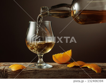 Old Fashioned cocktail with ice and orange peel on a old wooden table. Old Fashioned cocktail with ice and orange peel on a old wooden table. 132406394