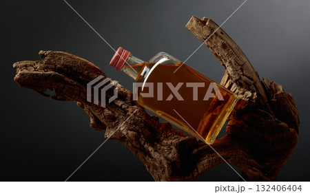 Bottle of whiskey on a old snags. Bottle of whiskey on a old snags. 132406404