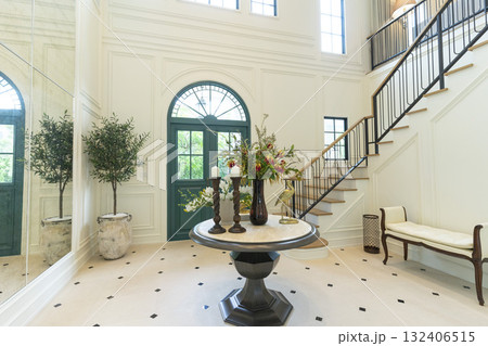 Foyer space with reception console in new luxury home with staircase. 132406515