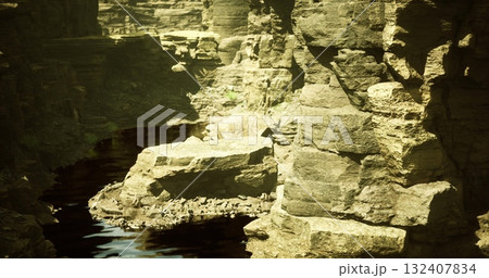 A tranquil landscape showcases dramatic rock formations beside calm water. The unique geological features create a peaceful atmosphere in a secluded natural setting. 132407834