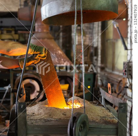 Foundry ferrous metal is melted in an induction furnace of metallurgical plant Foundry ferrous metal is melted in an induction furnace of metallurgical plant 132407919