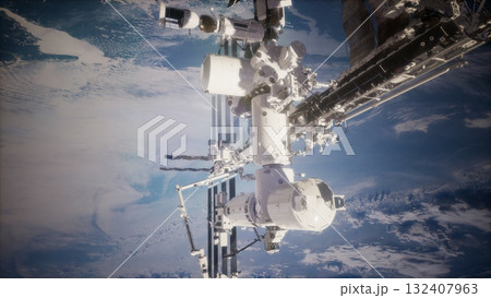 Under the mesmerizing view of Earth, the International Space Station hovers silently, showcasing human innovation in low Earth orbit while astronauts conduct vital experiments. Under the mesmerizing view of Earth, the International Space Station hovers silently, showcasing human innovation in low Earth orbit while astronauts conduct vital experiments. 132407963