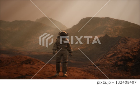 A lone astronaut stands on a rugged, reddish terrain, surrounded by towering mountains. The atmosphere is thin, creating a mysterious and otherworldly quality to the environment. 132408407