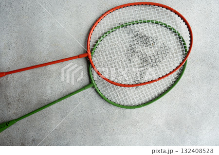 badminton racquets on the concrete background 132408528