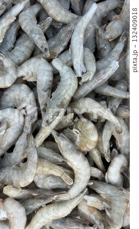 Raw shrimp piled together display seafood freshness and texture for cooking or culinary background 132409018