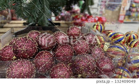 Christmas ornaments in store display with variety of festive decorations and background 132409049