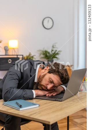 Middle-aged businessman exhausted types report falls asleep on laptop keyboard face down during work Middle-aged businessman exhausted types report falls asleep on laptop keyboard face down during work 132409133