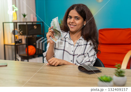 Indian woman counts dollars money cash satisfied with salary bonus feeling proud profitable success 132409157